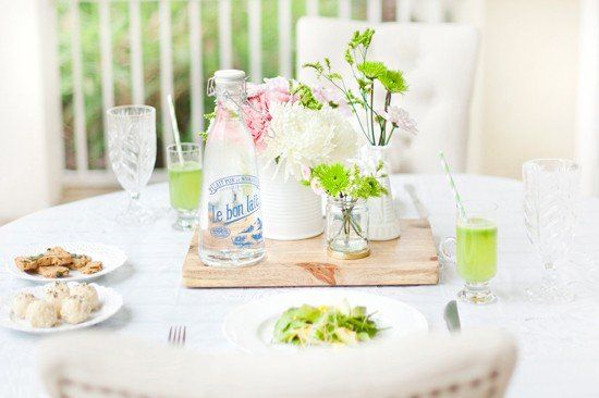 St. Patrick's Day dog-friendly brunch table setting with green drinks, dog treats, and fresh flowers.