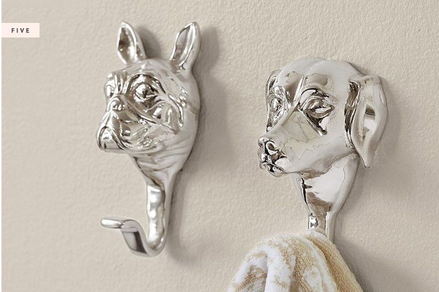 Stylish silver dog head wall hooks hanging a towel, featured in our curated dog product shopping guides.