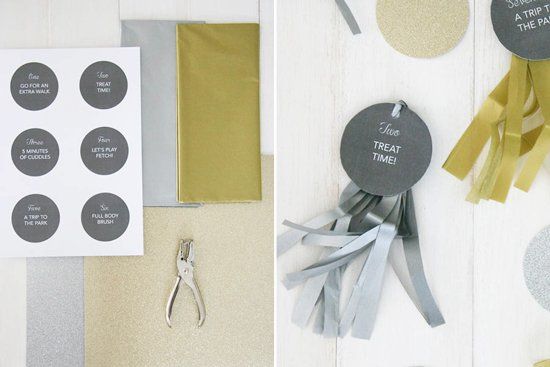 DIY dog Christmas gift advent calendar activity tags with gold and silver ribbon tassels.