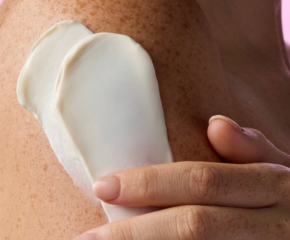 Applying smooth, cruelty-free skincare cream to skin, promoting a natural and cruelty-free lifestyle for dog mums.