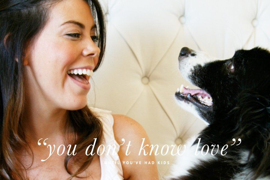 Smiling woman looking at her dog with overlay text: "you don't know love" until you've had kids.
