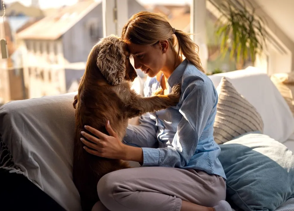 Dog mom cuddling her dog