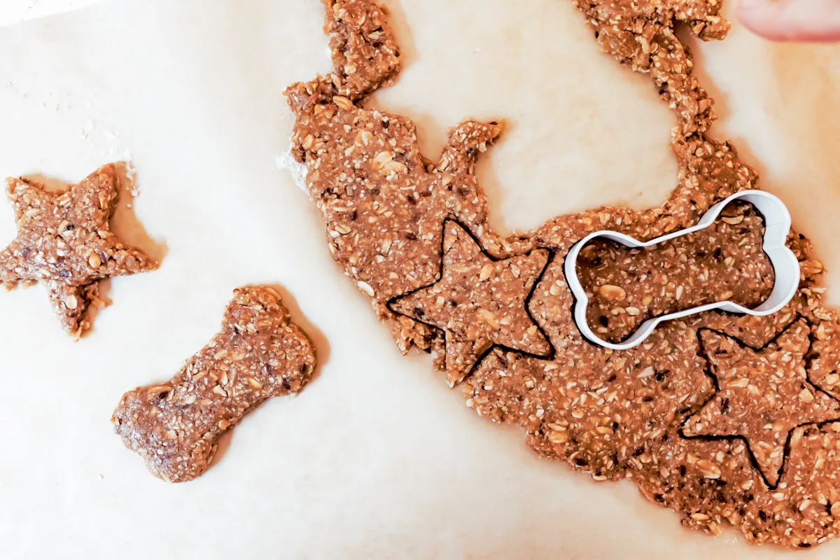 cutting cookie shapes using peanut butter dog treats dough